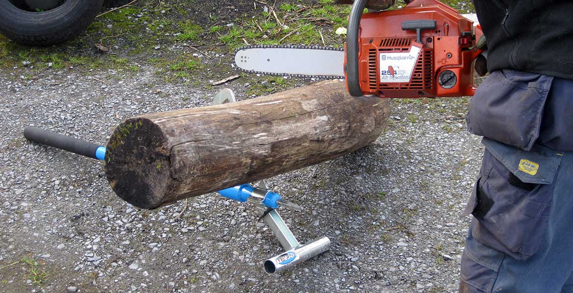 LogRite cant hook with log stand accessory tool being used to cut timber.